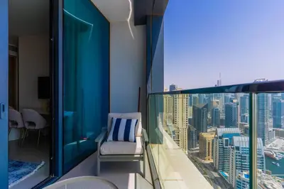 a balcony with a chair and a view of a city at 1BR •The Address Beach Residence - High floor in Dubai
