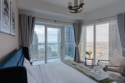 a bedroom with a bed and a large window at Fantastic View l Great Amenities l Superb Location in Dubai