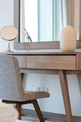 a desk with a chair in front of a mirror at Fantastic View l Great Amenities l Superb Location in Dubai