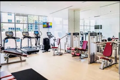 a gym with several treadmills and exercise machines at Fantastic View l Great Amenities l Superb Location in Dubai