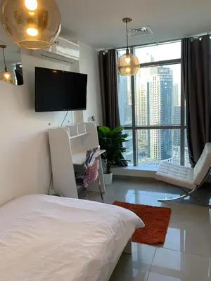 a bedroom with a bed and a flat screen tv at Coliving Sharing Hostel ll in Dubai