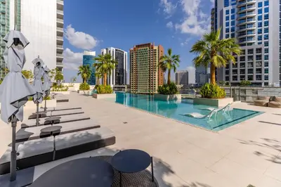 a pool with a view of the city at Maison Privee - Exquisite Duplex with Private Patio & Loft Living in Dubai