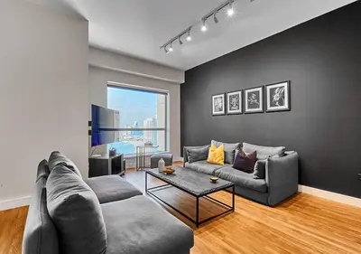 a living room with a couch and a table at First Class Apartments in Heart of JBR, Steps to the Beach - 121 Living in Dubai