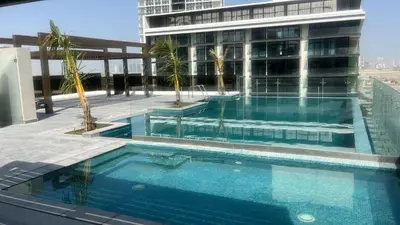 a swimming pool on the roof of a building at Stylish Studio with Gym and Pool in Dubai