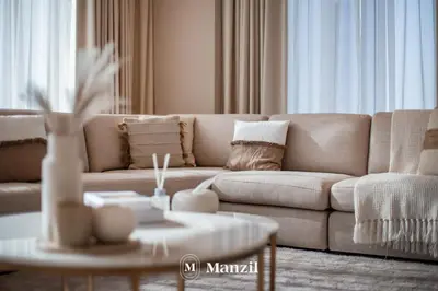 a living room with a couch and a table at Manzil - Luxury 4BR Penthouse with Harbour View & Private Terrace at Dubai Creek Harbour in Dubai