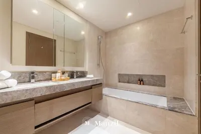 a bathroom with a tub and a large mirror at Manzil - Luxury 4BR Penthouse with Harbour View & Private Terrace at Dubai Creek Harbour in Dubai
