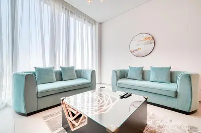 a living room with two blue chairs and a coffee table at Address JBR Marina View, Jumeirah Beach Residence, Dubai Marina - Mint Stay in Dubai