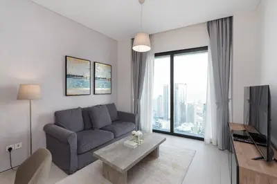 a living room with a couch and a large window at Address JBR Marina View, Jumeirah Beach Residence, Dubai Marina - Mint Stay in Dubai
