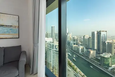 a room with a window with a view of a city at Address JBR Marina View, Jumeirah Beach Residence, Dubai Marina - Mint Stay in Dubai