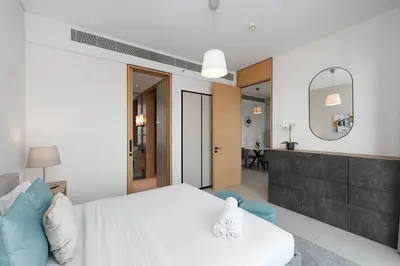 a bedroom with a white bed and a mirror at Address JBR Marina View, Jumeirah Beach Residence, Dubai Marina - Mint Stay in Dubai