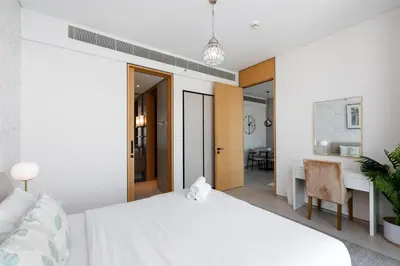 a bedroom with a white bed and a desk at Address JBR Marina View, Jumeirah Beach Residence, Dubai Marina - Mint Stay in Dubai