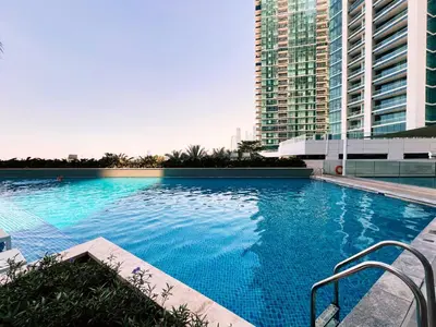 a large blue swimming pool with a tall building at Address JBR Marina View, Jumeirah Beach Residence, Dubai Marina - Mint Stay in Dubai