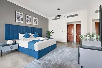 a blue and white bedroom with a large bed at StoneTree - Luxurious 1BR with Beach Access in Dubai