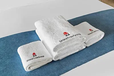 three white towels sitting on top of a table at StoneTree - Luxurious 1BR with Beach Access in Dubai