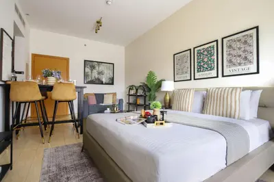 a bedroom with a large white bed and a table at Frank Porter - Genesis by Meraki in Dubai