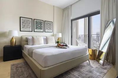a bedroom with a large bed and a large window at Frank Porter - Genesis by Meraki in Dubai