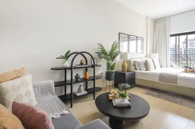 a living room with a couch and a table at Frank Porter - Genesis by Meraki in Dubai