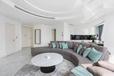 a living room with a couch and a table at StoneTree - Panoramic View - Spacious 2BR in Dubai
