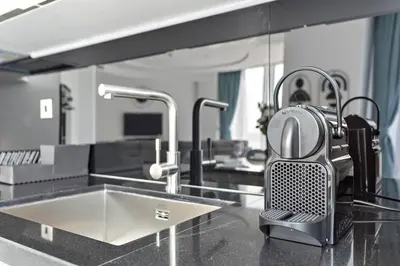 a kitchen with a sink and two faucets at StoneTree - Panoramic View - Spacious 2BR in Dubai