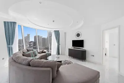 a living room with a couch and a table at StoneTree - Panoramic View - Spacious 2BR in Dubai