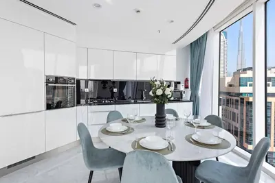 a kitchen and dining room with a table and chairs at StoneTree - Panoramic View - Spacious 2BR in Dubai