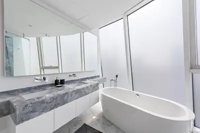 a white bathroom with a tub and a sink at StoneTree - Panoramic View - Spacious 2BR in Dubai