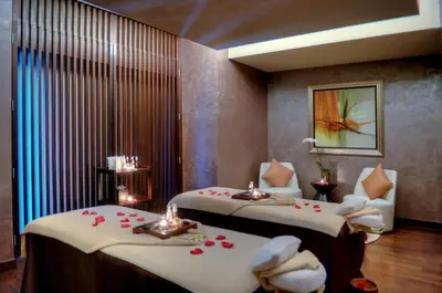 a hotel room with two beds with roses on them at Emaar Marina Residences - formerly Address Dubai Marina in Dubai