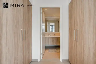 a bathroom with two wooden doors and a sink at Mira Holiday Homes - Fully furnished 2 bedroom in Dubai Hills in Dubai