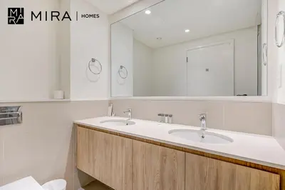 a bathroom with two sinks and a mirror at Mira Holiday Homes - Fully furnished 2 bedroom in Dubai Hills in Dubai