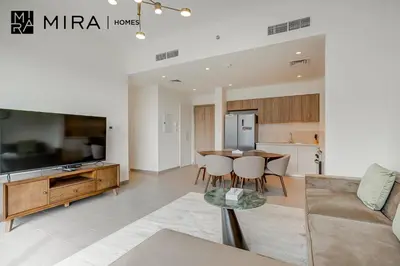 a living room with a table and a couch at Mira Holiday Homes - Fully furnished 2 bedroom in Dubai Hills in Dubai