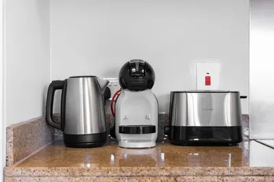 two coffeemakers and a coffee maker on a counter at The Residences Towers - 3 Minute Walk to Dubai Fountain in Dubai