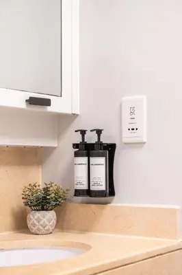 two bottles ofodorizers sitting on a shelf above a sink at The Residences Towers - 3 Minute Walk to Dubai Fountain in Dubai