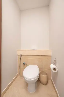 a bathroom with a white toilet and a trash can at The Residences Towers - 3 Minute Walk to Dubai Fountain in Dubai