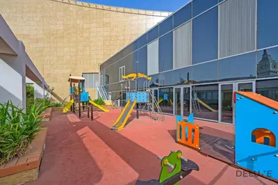an empty playground in front of a building at Gleeful 2BR at Sky Gardens DIFC by Deluxe Holiday Homes in Dubai