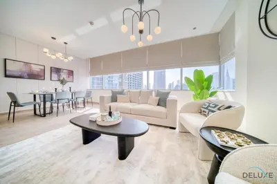 a living room with a couch and a table at Gleeful 2BR at Sky Gardens DIFC by Deluxe Holiday Homes in Dubai