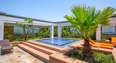 a backyard with a swimming pool and a palm tree at Gleeful 2BR at Sky Gardens DIFC by Deluxe Holiday Homes in Dubai