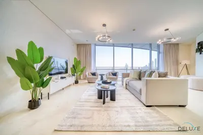 a living room with a couch and a tv at Amazing 2BR at Sky Gardens DIFC by Deluxe Holiday Homes in Dubai