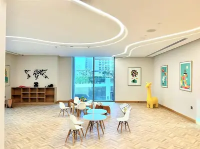a dining room with a table and chairs and a room with windows at Luxury Dubai Creek Balcony & View in Dubai