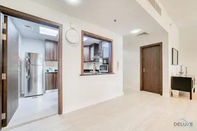 an empty room with a door and a kitchen at Urbane 2BR At Shams 1 JBR by Deluxe Holiday Homes in Dubai
