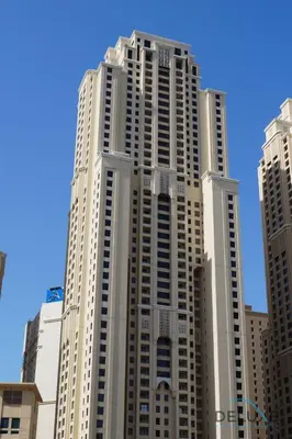 a tall white building with many windows at Urbane 2BR At Shams 1 JBR by Deluxe Holiday Homes in Dubai