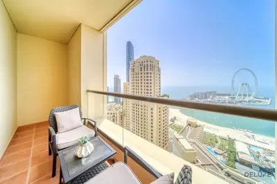 a balcony with a view of the city and the ocean at Urbane 2BR At Shams 1 JBR by Deluxe Holiday Homes in Dubai