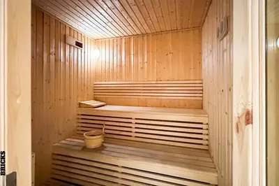 a wooden sauna with a bucket in it at Sleek One Bed Sobha Creek Vistas Reserve Tower A in Dubai