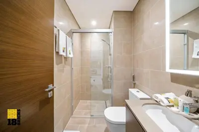 a bathroom with a shower and a toilet and a sink at Sleek One Bed Sobha Creek Vistas Reserve Tower A in Dubai