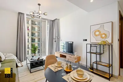 a living room with a couch and a table at Sleek One Bed Sobha Creek Vistas Reserve Tower A in Dubai