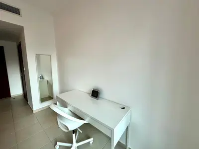 a white desk with a chair and a mirror at Lux BnB I The Residences I Sky Line Views in Dubai