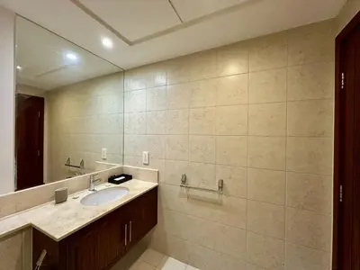 a bathroom with a sink and a mirror at Lux BnB I The Residences I Sky Line Views in Dubai