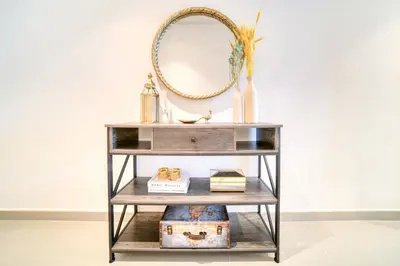 a console table with a mirror and a shelf at Dubai Elegance: 1BR with DIFC & Zabeel Views in Dubai