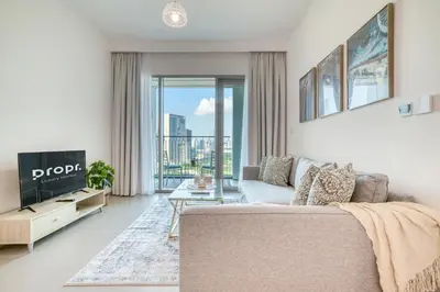 a living room with a couch and a tv at Dubai Elegance: 1BR with DIFC & Zabeel Views in Dubai