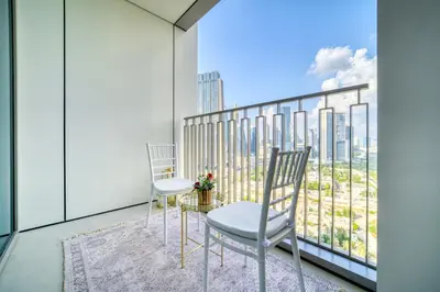 a balcony with two chairs and a table at Dubai Elegance: 1BR with DIFC & Zabeel Views in Dubai