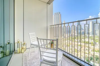 a balcony with two chairs and a view of the city at Dubai Elegance: 1BR with DIFC & Zabeel Views in Dubai